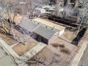 Aerial view of a well-maintained home with a fenced backyard and mature trees at 1104 Sherri Mar Ct, Longmont, CO 80501