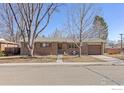 Lovely single-story brick home with mature trees and a well-manicured front yard at 1104 Sherri Mar Ct, Longmont, CO 80501