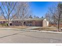 Charming single-story brick home featuring an attached garage and mature landscaping at 1104 Sherri Mar Ct, Longmont, CO 80501