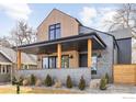 Charming two-story home with a modern design, covered porch, and wood and brick facade at 1223 Main St, Louisville, CO 80027