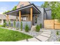 Inviting front porch with wooden pillars, gray brick, and stylish landscaping creates curb appeal at 1223 Main St, Louisville, CO 80027