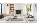 Bright living room featuring a cozy fireplace, built-in shelves and lots of natural light at 1223 Main St, Louisville, CO 80027