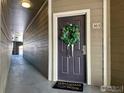 Welcoming front door with decorative wreath and 'Welcome to our Home' doormat at 1465 Blue Sky Cir # 303, Erie, CO 80516