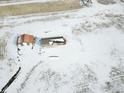 Breathtaking overhead view of the snow-covered property, featuring the house and a detached garage at 17910 County Road 38, Platteville, CO 80651