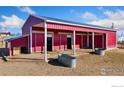 A large red barn with multiple stalls provides ample space for animals at 200 Bothun Rd, Berthoud, CO 80513