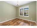 Well-lit bedroom featuring hardwood floors, neutral walls and a window view at 2112 Springs Pl, Longmont, CO 80504