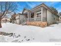 Attractive home with a covered front porch and brick accents, perfect for curb appeal at 2112 Springs Pl, Longmont, CO 80504