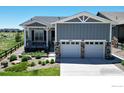 Charming home featuring a two-car garage, inviting porch, and well-maintained landscaping at 22674 E Henderson Dr, Aurora, CO 80016