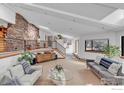 Bright living room showcasing a stone column, skylights, and a modern staircase at 2796 Lee Hill Dr, Boulder, CO 80302