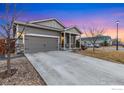 Well-maintained single-story home featuring stone accents, a two-car garage, and a concrete driveway at 2912 Urban Pl, Berthoud, CO 80513