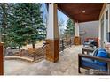 Inviting covered porch with stone flooring and pillars with comfortable outdoor seating at 2925 4Th St, Boulder, CO 80304