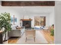 Cozy living room with hardwood floors, fireplace, and bright natural light at 3323 Hickok Pl, Boulder, CO 80301