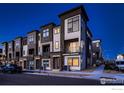 Eye-level exterior of modern townhomes displaying mixed textures and hues with inviting architectural details at 375 Marshall Rd, Superior, CO 80027