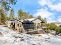 Two story home with glass panel sunroom and second story deck overlooking the backyard at 412 Wild Horse Cir, Boulder, CO 80304