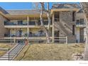 Multi-story townhome featuring balconies and stairs leading to the upper levels at 4639 S Lowell Blvd, Denver, CO 80236