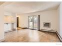 Bright living room featuring wood floors and a sliding glass door to the outdoor area at 4639 S Lowell Blvd, Denver, CO 80236