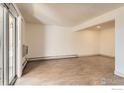 An empty living room features wooden floors, neutral walls, and plenty of space at 4639 S Lowell Blvd, Denver, CO 80236