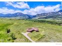 Aerial view of house with attached garage and picturesque view of mountains and the horizon at 4702 Eldorado Springs Dr, Boulder, CO 80303