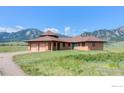 Exterior elevation of residence boasts an attached garage, circular-style design and mountain views at 4702 Eldorado Springs Dr, Boulder, CO 80303