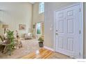 Inviting living room featuring high ceilings, neutral tones, and a large window providing ample natural light at 510 Folklore Ave, Longmont, CO 80504