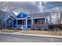 Inviting single Gathering home with a classic blue exterior, covered front porch, and landscaped front yard at 5126 Mt Buchanan Ave, Frederick, CO 80504