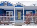 Inviting front porch with white columns and a sunny yellow front door at 5126 Mt Buchanan Ave, Frederick, CO 80504