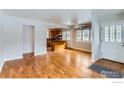 Open-concept living area featuring hardwood floors, lots of natural light, and seamless flow to the kitchen at 535 Dewey Ave, Boulder, CO 80304