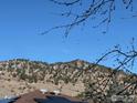 Beautiful mountain view from the home's rooftop solar panels with clear blue skies behind at 535 Dewey Ave, Boulder, CO 80304