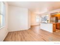 Bright living room with hardwood floors, large windows, and an open layout leading to the kitchen at 635 Gooseberry Dr # 1908, Longmont, CO 80503