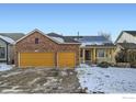 Charming home showcasing a brick facade, two-car garage, solar panels, and a welcoming front porch at 6596 Silverleaf Ave, Firestone, CO 80504