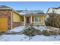 Inviting home exterior with a cozy porch, well-maintained landscaping, and a charming purple front door at 6596 Silverleaf Ave, Firestone, CO 80504