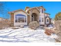 Charming two-story home with a manicured lawn and inviting curb appeal on a sunny day at 6943 Saddleback Ave, Firestone, CO 80504