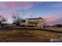 Two story home with brick and siding, landscaped yard and circular drive at 7208 Secrest Ct, Arvada, CO 80007