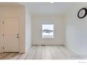 Bright living room with hardwood floors, a large window, and ample natural light at 7333 Ellingwood Cir, Frederick, CO 80504