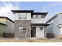 Modern two-story home with stone facade and minimalist landscaping at 735 Discovery Pkwy, Superior, CO 80027