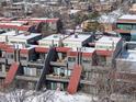 An aerial showing the townhome's design, outdoor living spaces, and the surrounding neighborhood in winter at 856 Walnut St # A, Boulder, CO 80302