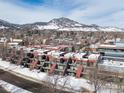 Aerial view of townhomes, displaying their architectural details and surrounding landscape with snow-capped mountains at 856 Walnut St # A, Boulder, CO 80302