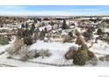 Expansive aerial view of a well-manicured property with surrounding neighborhood and open spaces at 8916 Prairie Knoll Dr, Longmont, CO 80503