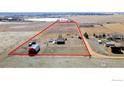 Expansive aerial view of a farmhouse with a barn on a large property outlined in red at 9089 Vermillion Rd, Longmont, CO 80503