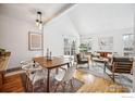 Open concept living and dining area with hardwood floors and natural light at 910 Homer Cir, Lafayette, CO 80026