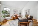 Inviting living room with a vaulted ceiling, hardwood floors and an eye-catching painting at 910 Homer Cir, Lafayette, CO 80026