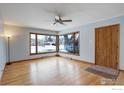 Bright living room featuring large windows, hardwood floors, and a ceiling fan at 1315 Aspen St, Longmont, CO 80501