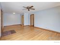 Large living room with ceiling fan, hardwood floors, and view to other rooms at 1315 Aspen St, Longmont, CO 80501