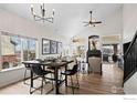 Bright dining room with vaulted ceilings, modern lighting, fireplace and large windows at 1495 Hickory Dr, Erie, CO 80516