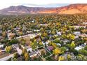 Stunning aerial view showcases the neighborhood and mountain views in the distance at 1635 Quince Ave, Boulder, CO 80304