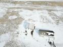 A high angle shot of a house and outbuilding surrounded by a snow-covered field at 17916 County Road 38, Platteville, CO 80651