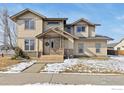 Inviting two-story home with stone accents, covered porch, and fresh landscaping at 2104 18Th Ave, Longmont, CO 80501