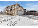 Spacious garage with driveway and a well-maintained wooden fence at 2104 18Th Ave, Longmont, CO 80501