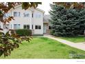 Inviting home with a well-maintained lawn, mature trees, and a classic facade, perfect for comfortable living at 2143 Meadow Ct, Longmont, CO 80501