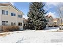 Exterior view of a snow covered condo community at 2143 Meadow Ct, Longmont, CO 80501